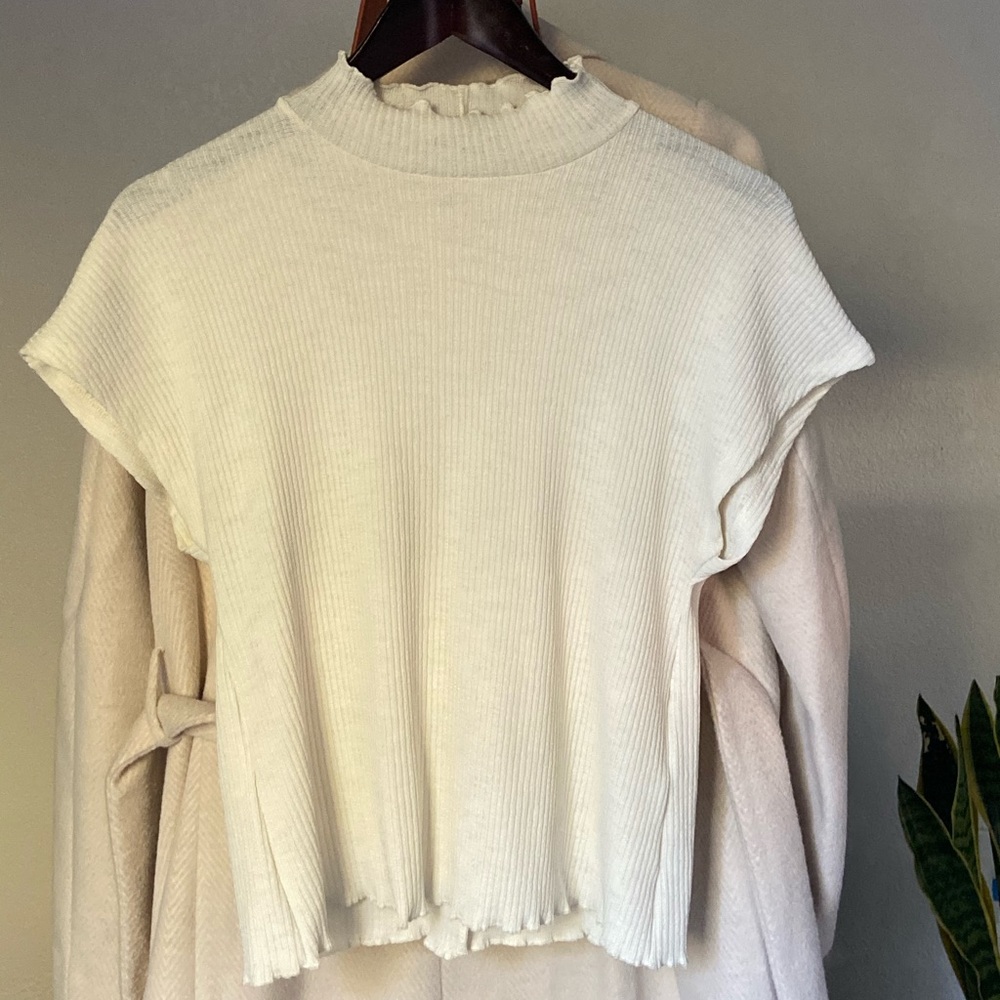 White ruffled turtle neck